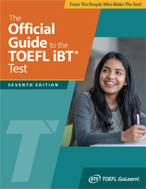 A college-aged woman holding a pen smiles off to her right