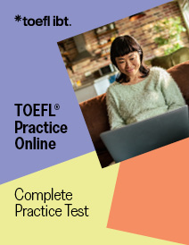 A college-aged woman with rectangular glasses types on her laptop